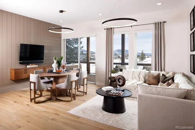 a living room with furniture a flat screen tv and a large window