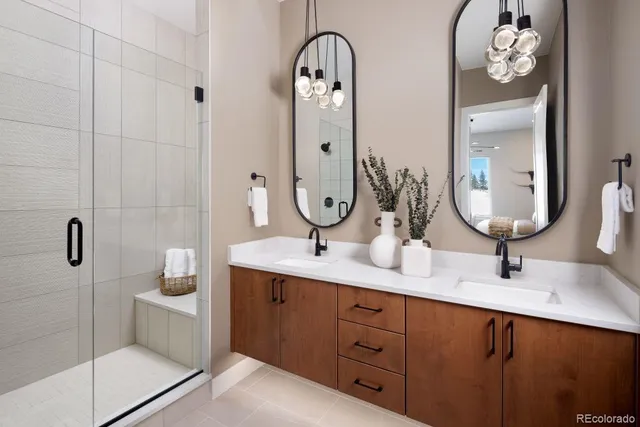 a bathroom with a double vanity sink mirror and toilet