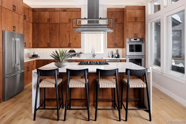 a view of kitchen with furniture and refrigerator