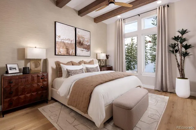 a bedroom with a large bed and a large window