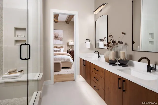 a en suite bathroom with double sink and a mirror
