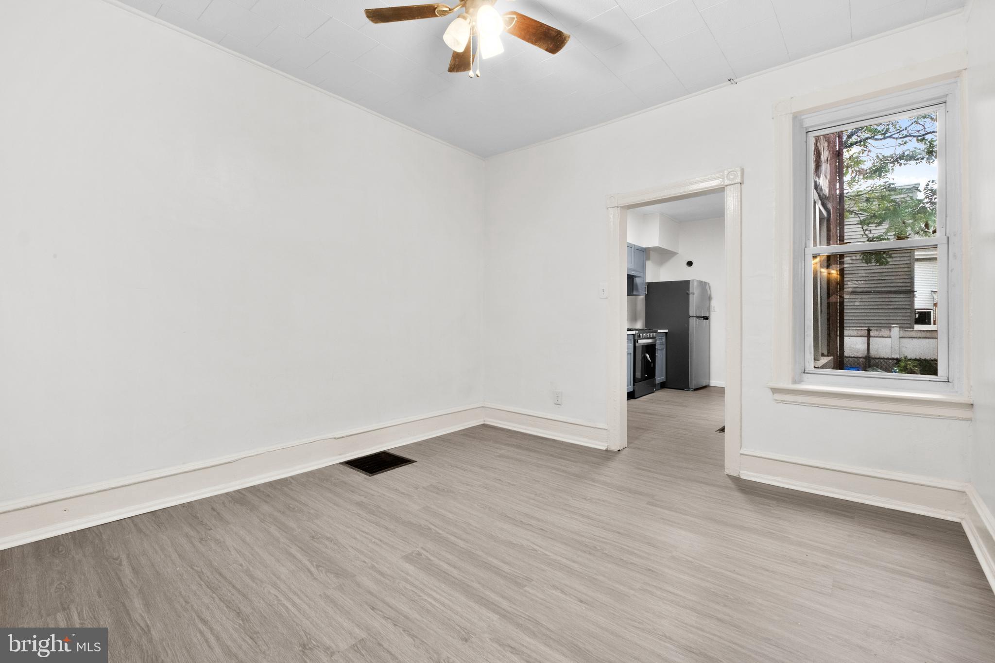 344 Middlesex Street Gloucester City, NJ 08030 - Photo 11 of 25 an empty room with wooden floor and windows
