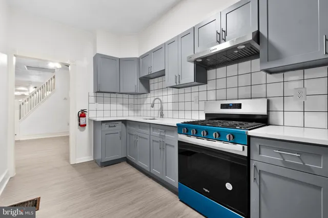 a kitchen with cabinets and steel appliances