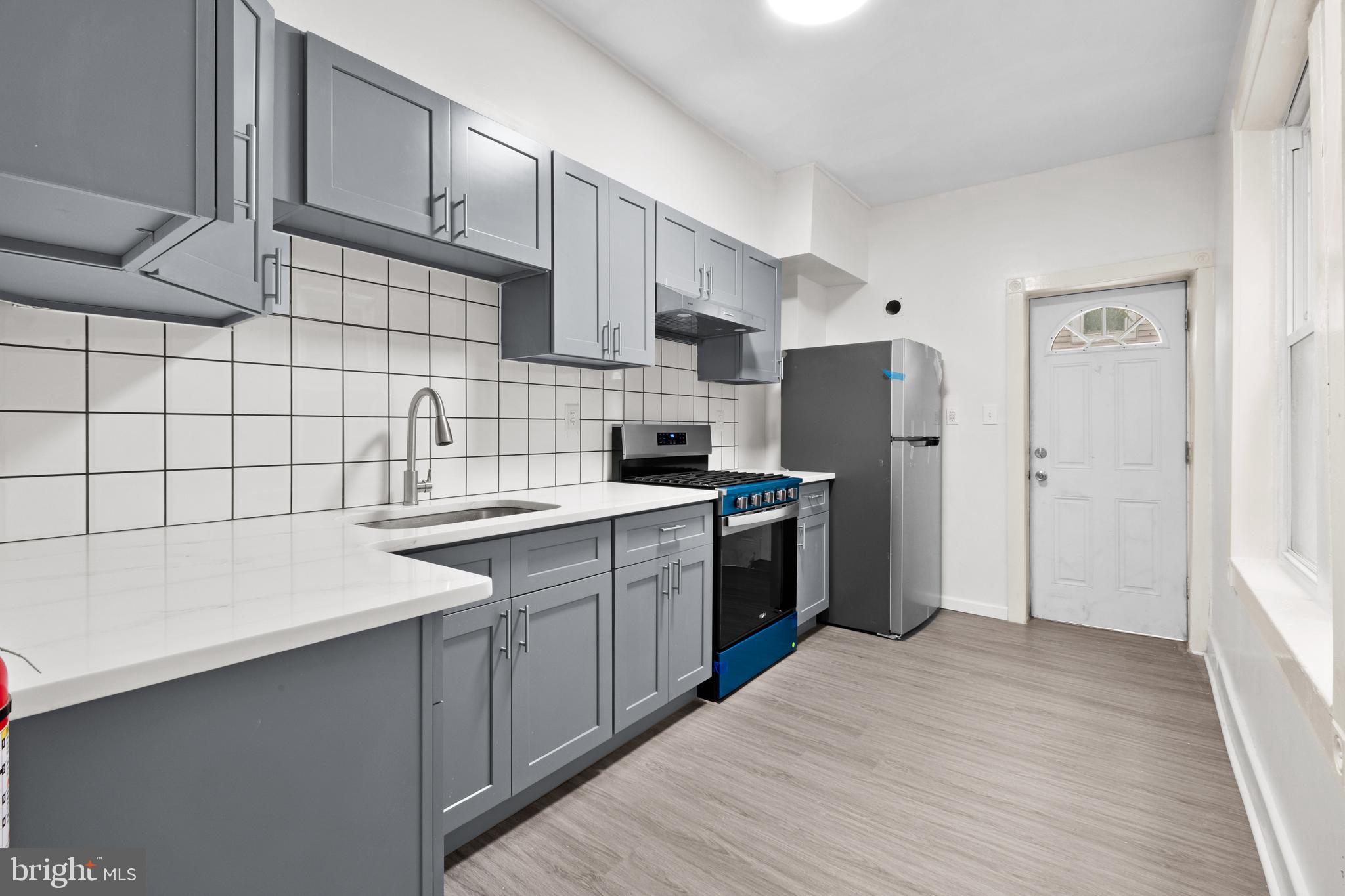 344 Middlesex Street Gloucester City, NJ 08030 - Photo 14 of 25 a kitchen with a sink a refrigerator and cabinets