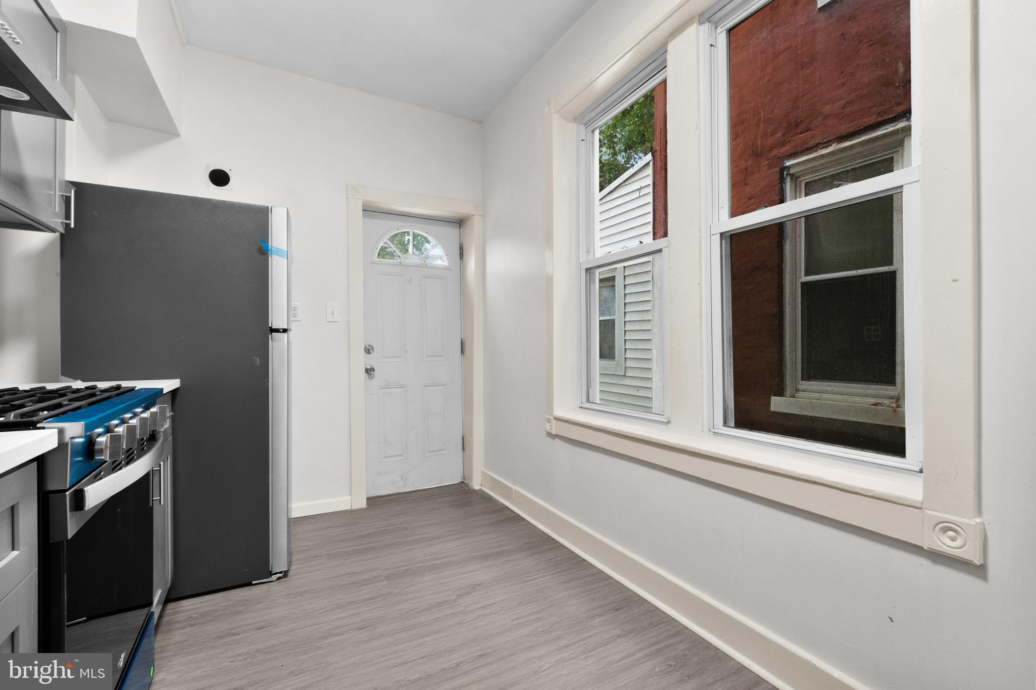 344 Middlesex Street Gloucester City, NJ 08030 - Photo 17 of 25 a view of an empty room with a window and wooden floor