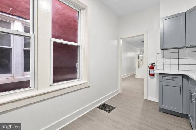 a view of a kitchen with wooden floor and cabinet