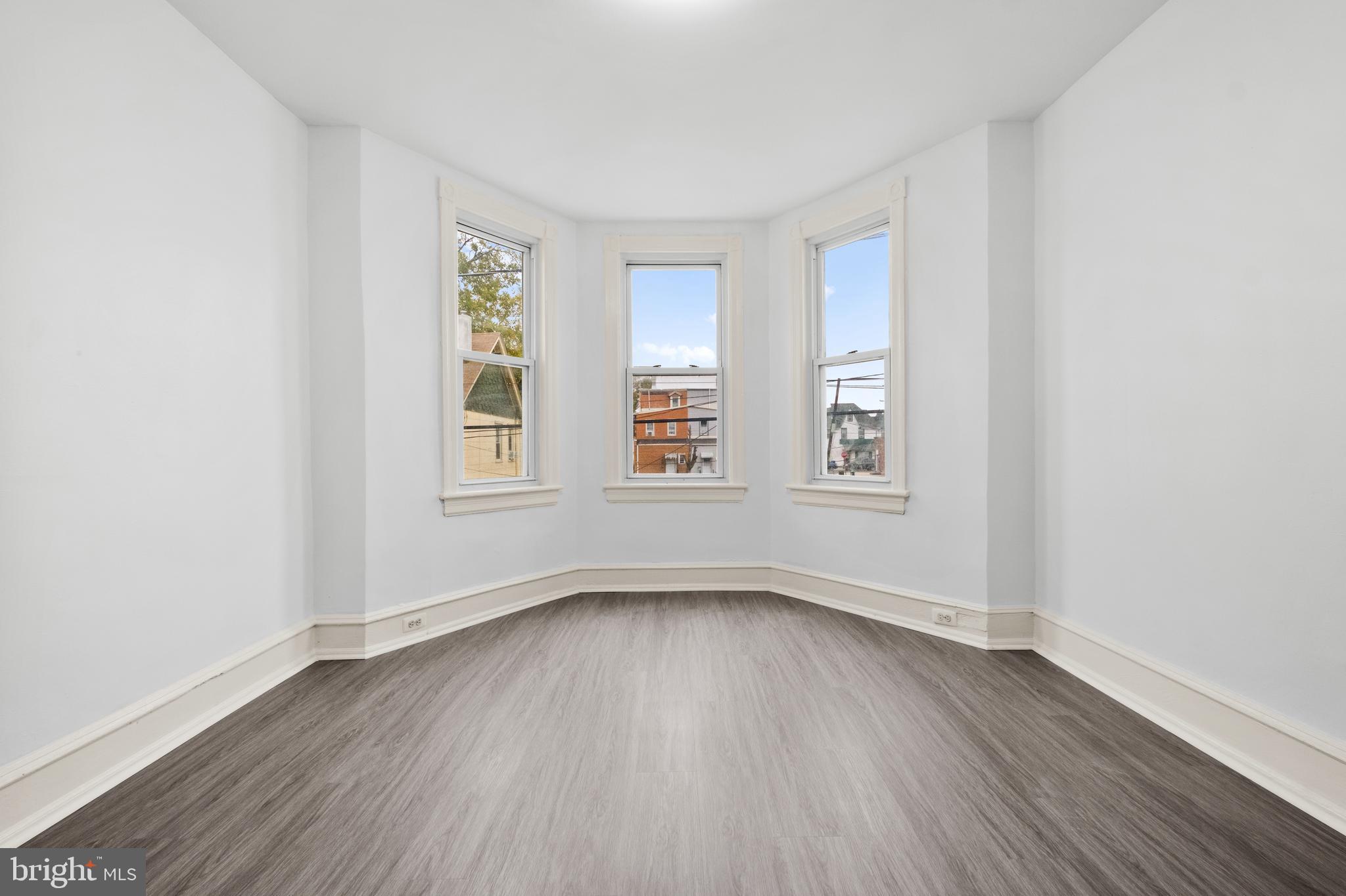 344 Middlesex Street Gloucester City, NJ 08030 - Photo 19 of 25 a view of an empty room with wooden floor and a window