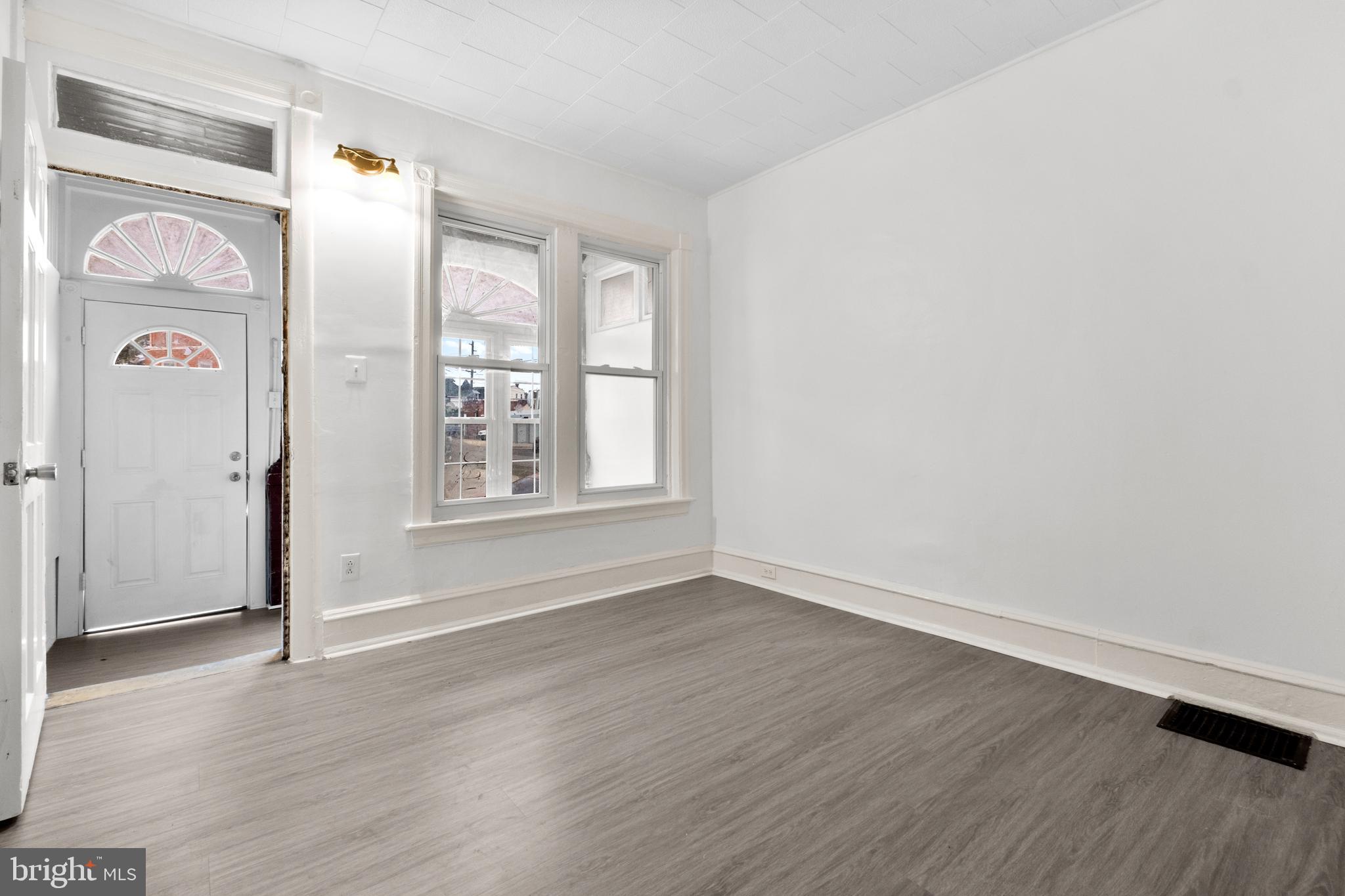 344 Middlesex Street Gloucester City, NJ 08030 - Photo 8 of 25 an empty room with wooden floor and windows