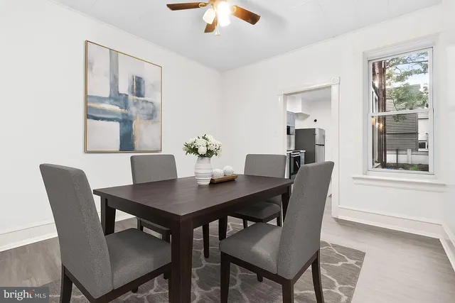 a view of a dining room with a table and chairs