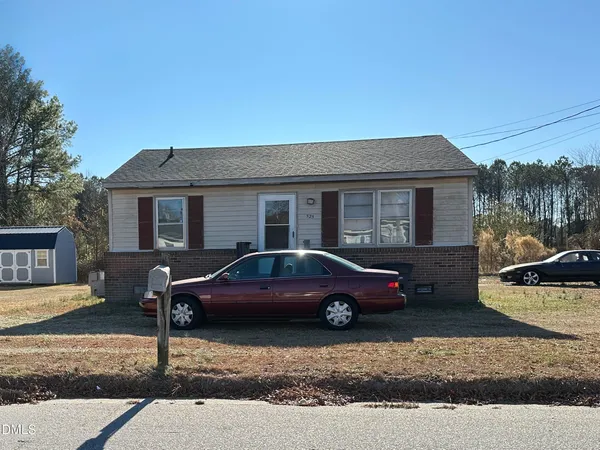 a front view of a house with parking space