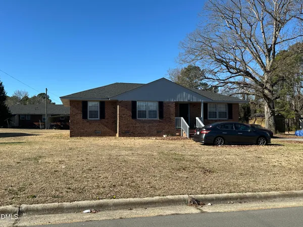 a view of a house with a yard covered in snow