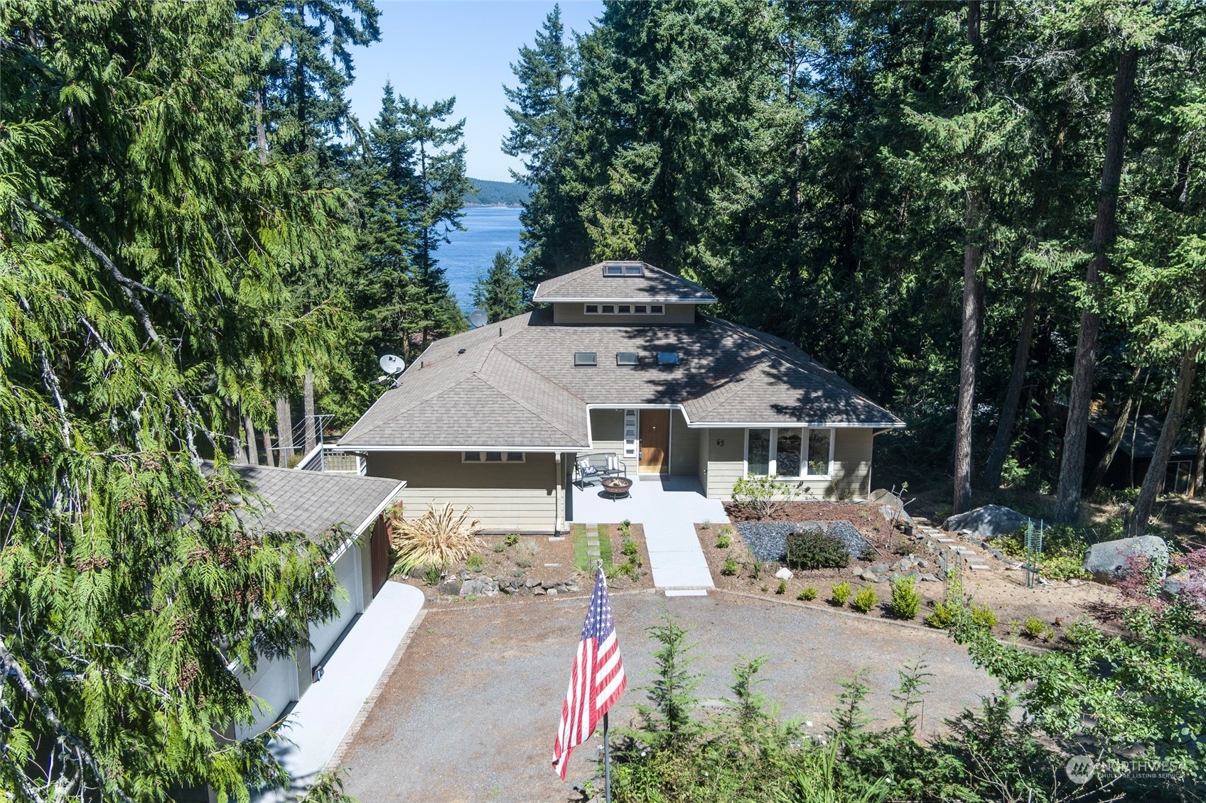63 Point Caution Drive Friday Harbor, WA 98250 - Photo 1 of 30 an aerial view of a house with yard and trees in the background