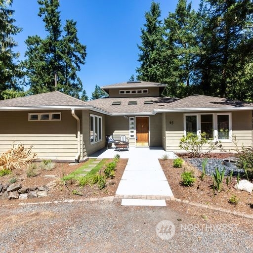 63 Point Caution Drive Friday Harbor, WA 98250 - Photo 6 of 30 a front view of a house with garden