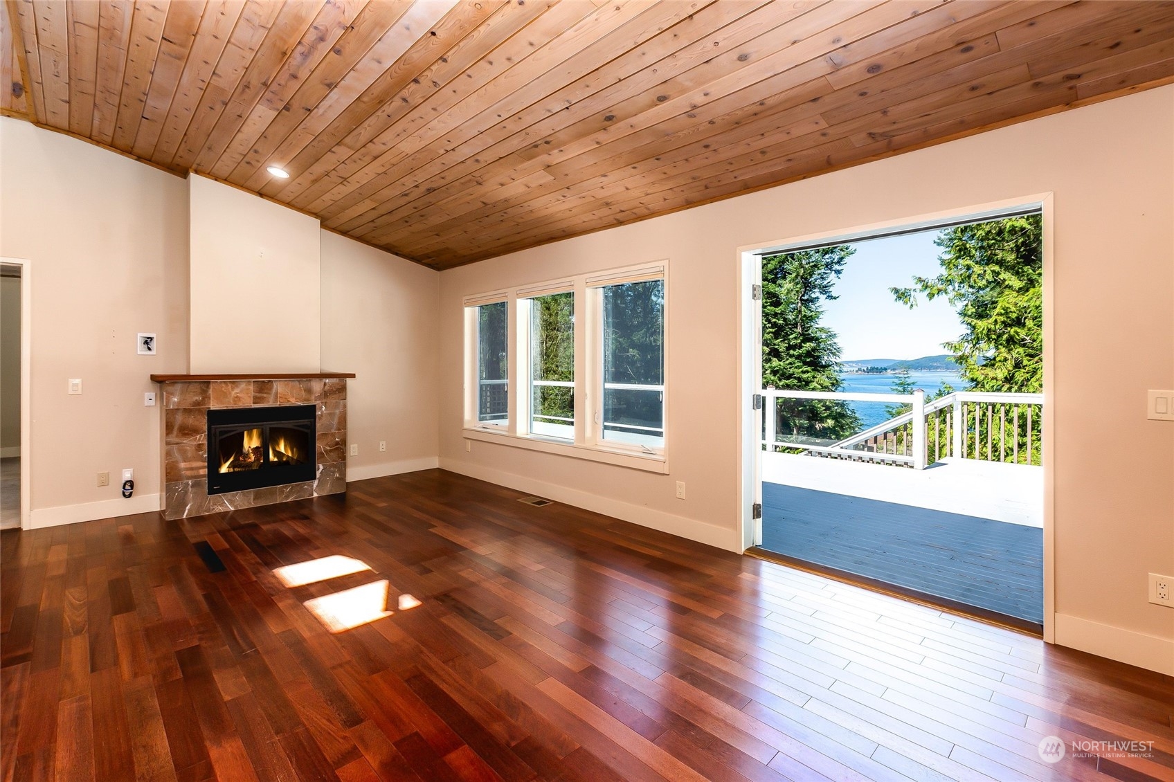 63 Point Caution Drive Friday Harbor, WA 98250 - Photo 9 of 30 a view of empty room with wooden floor and fireplace