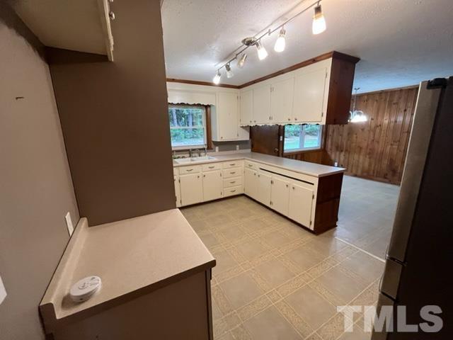 674 High Plains Road Roxboro, NC 27574 - Photo 3 of 16 a large white kitchen with a sink a microwave and cabinets