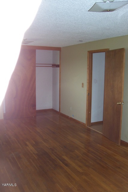 2660 Jones Road Wapato, WA 98951 - Photo 6 of 13 a view of an empty room with wooden floor