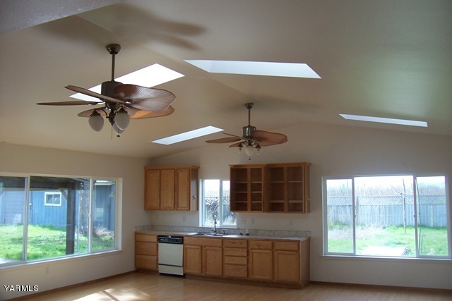 2660 Jones Road Wapato, WA 98951 - Photo 10 of 13 a kitchen with kitchen island a large window appliances and cabinets