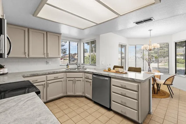 a kitchen with a sink appliances and cabinets
