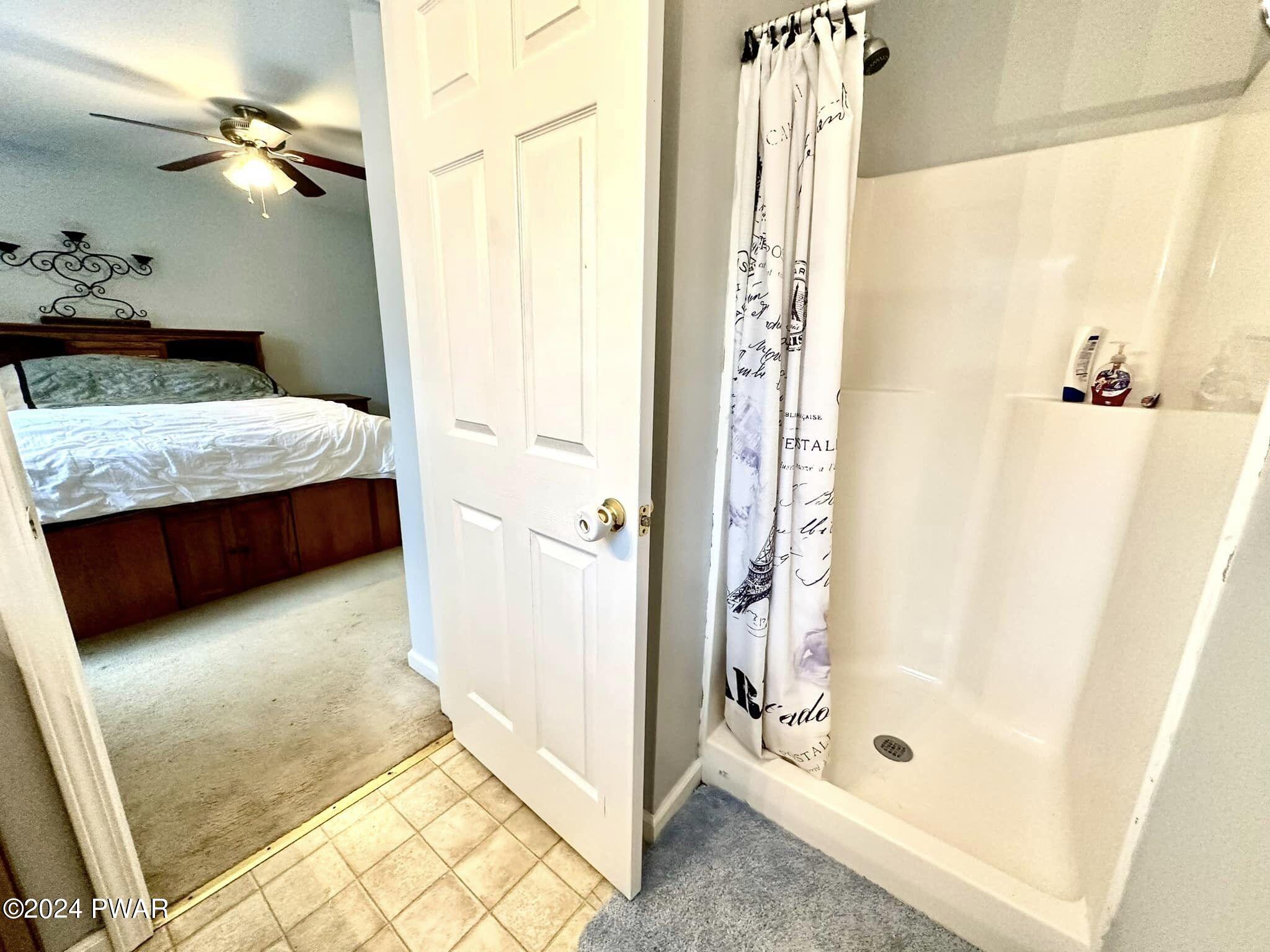 210 Fox Road Dingmans Ferry, PA 18328 - Photo 25 of 38 a bathroom with a granite countertop sink a mirror and shower