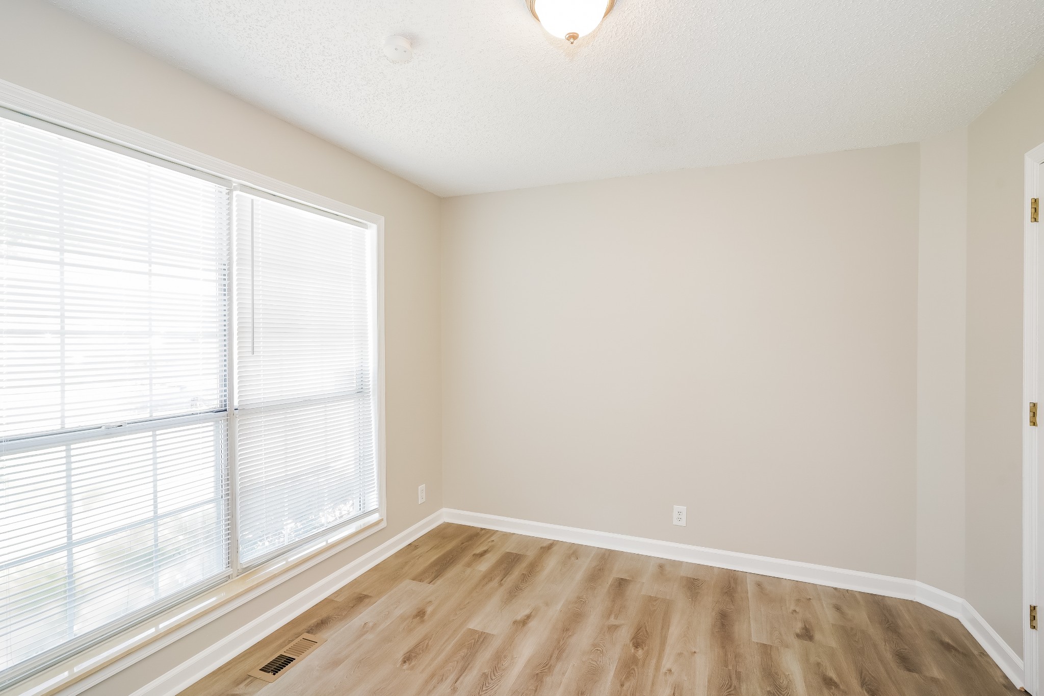 1204 Curran Court Antioch, TN 37013 - Photo 12 of 16 wooden floor in an empty room with a window