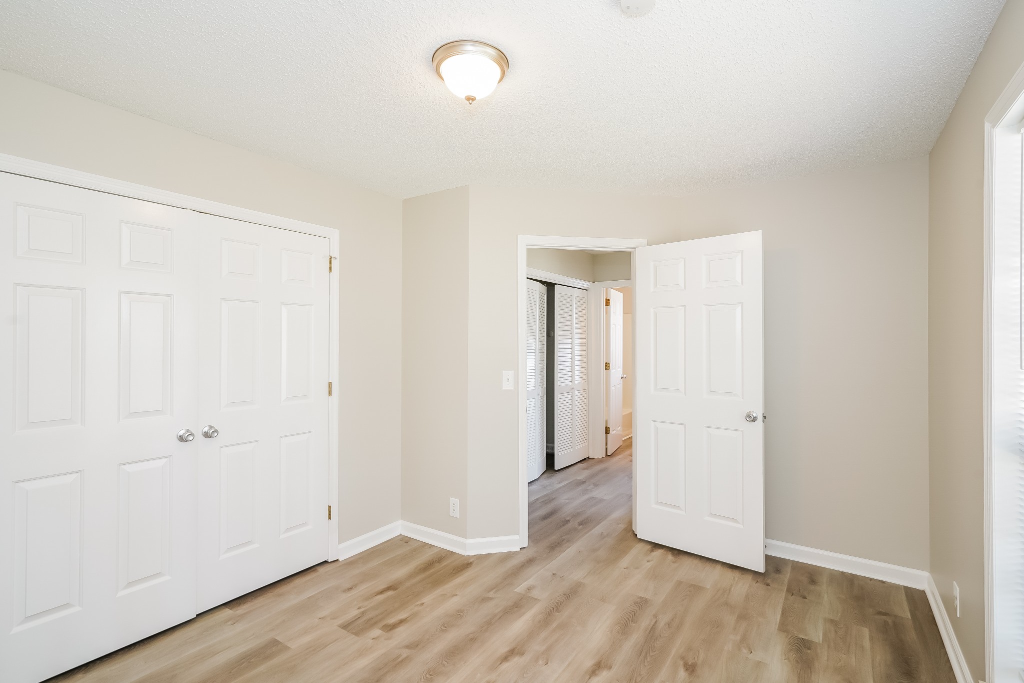 1204 Curran Court Antioch, TN 37013 - Photo 13 of 16 an empty room with wooden floor and windows