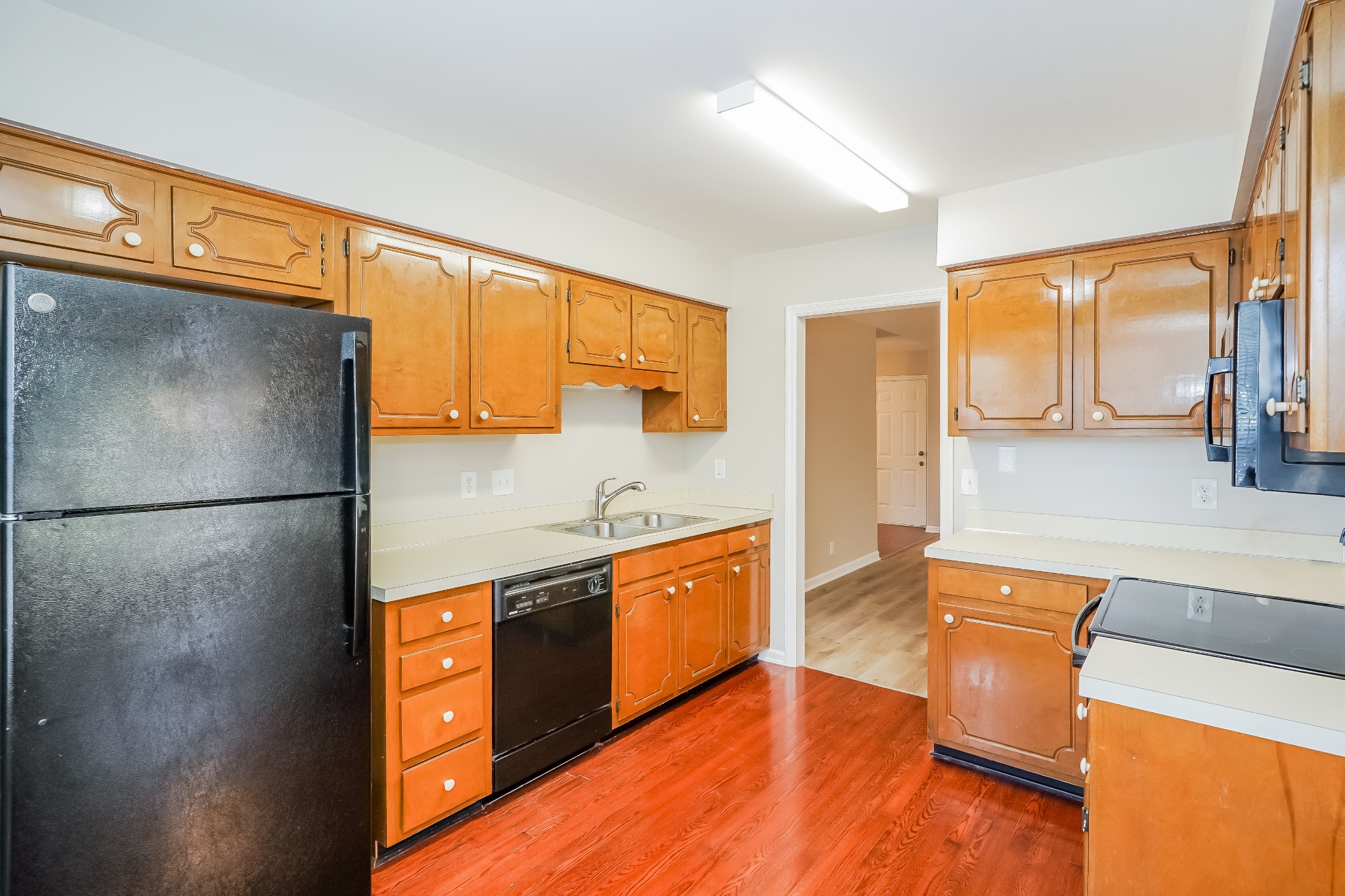 1204 Curran Court Antioch, TN 37013 - Photo 5 of 16 a kitchen with stainless steel appliances granite countertop a refrigerator a stove and a sink with wooden floors
