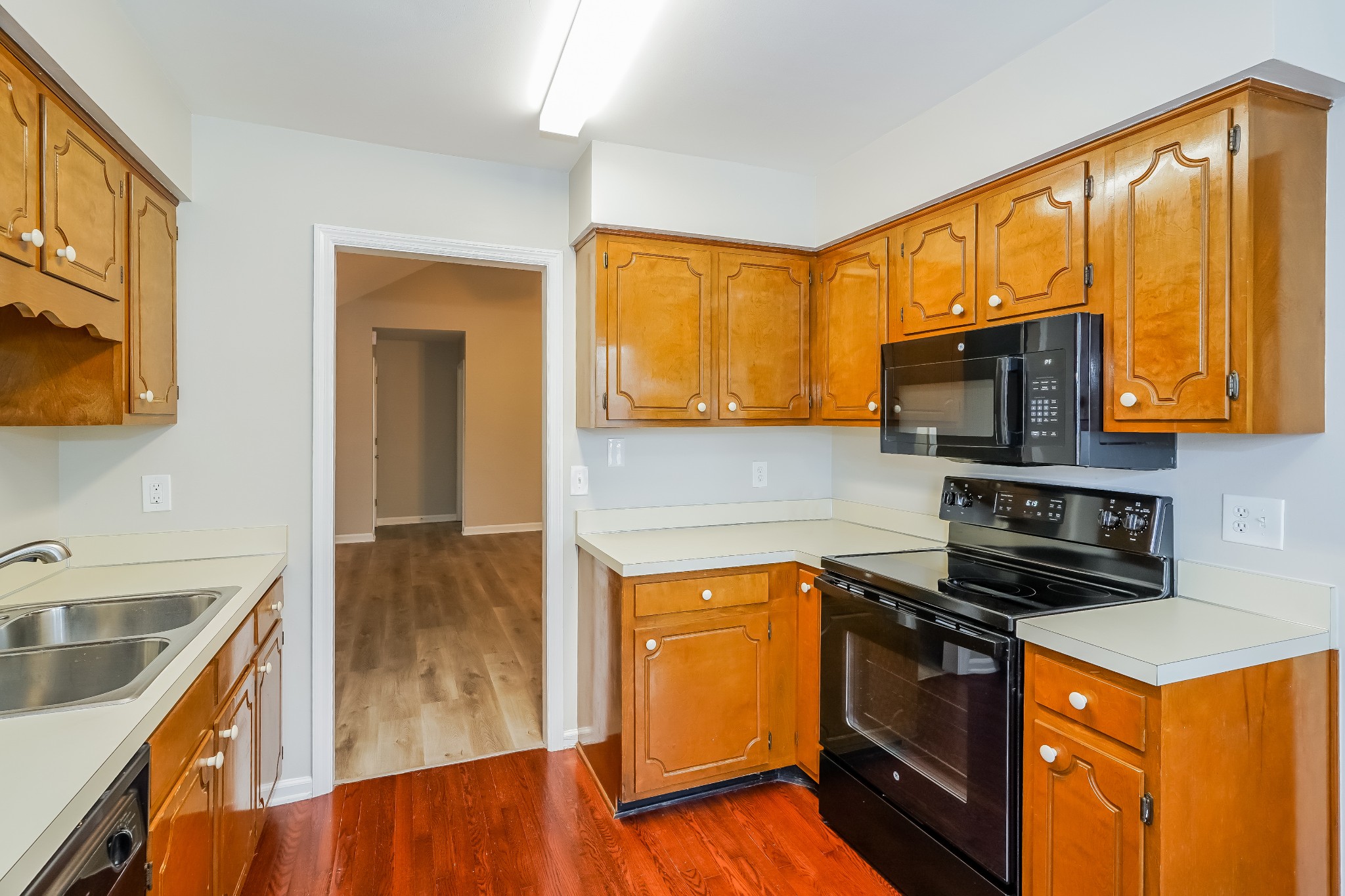 1204 Curran Court Antioch, TN 37013 - Photo 6 of 16 a kitchen with stainless steel appliances granite countertop a stove a sink and a microwave