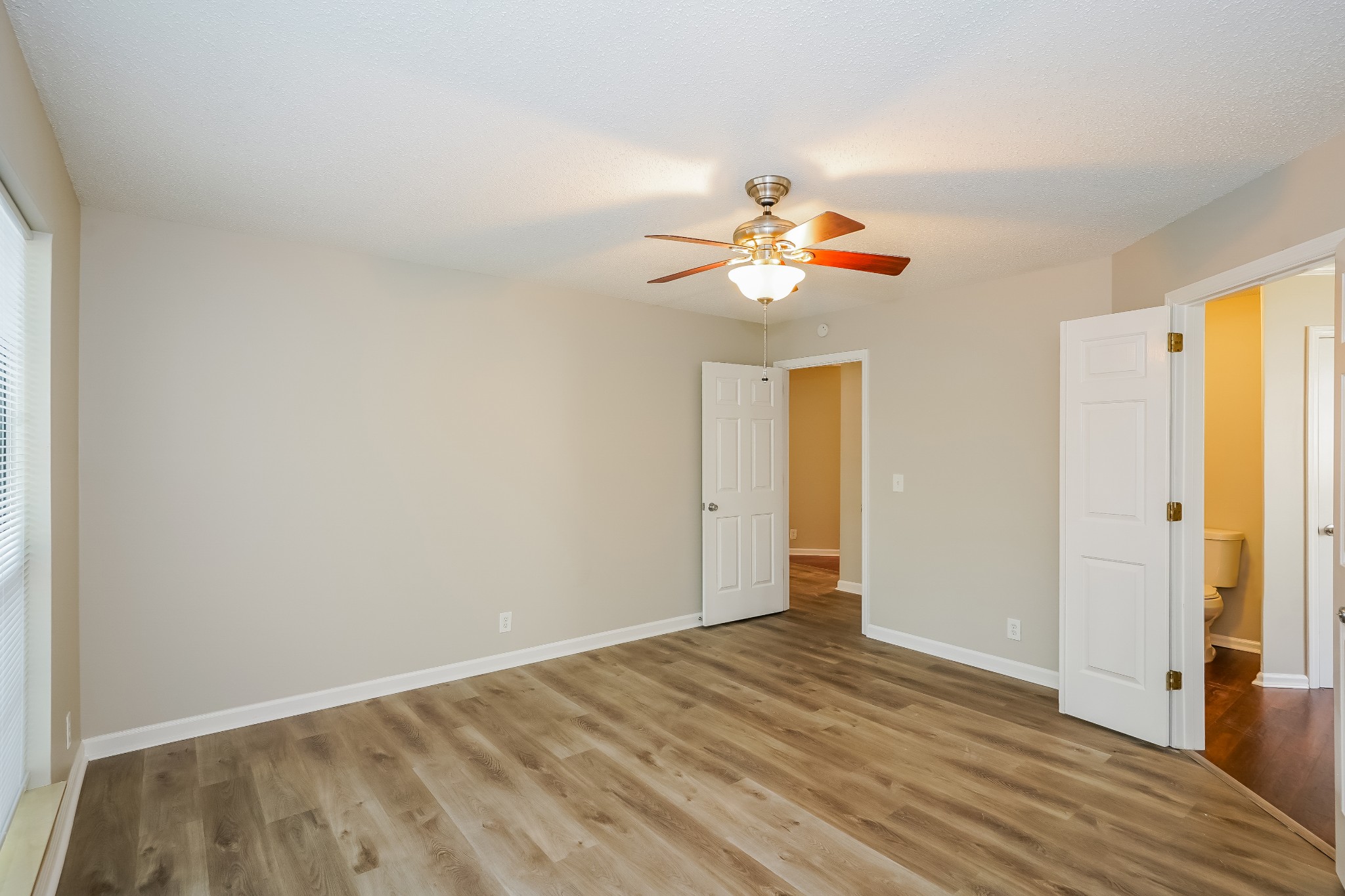 1204 Curran Court Antioch, TN 37013 - Photo 8 of 16 a view of an empty room with wooden floor and a window