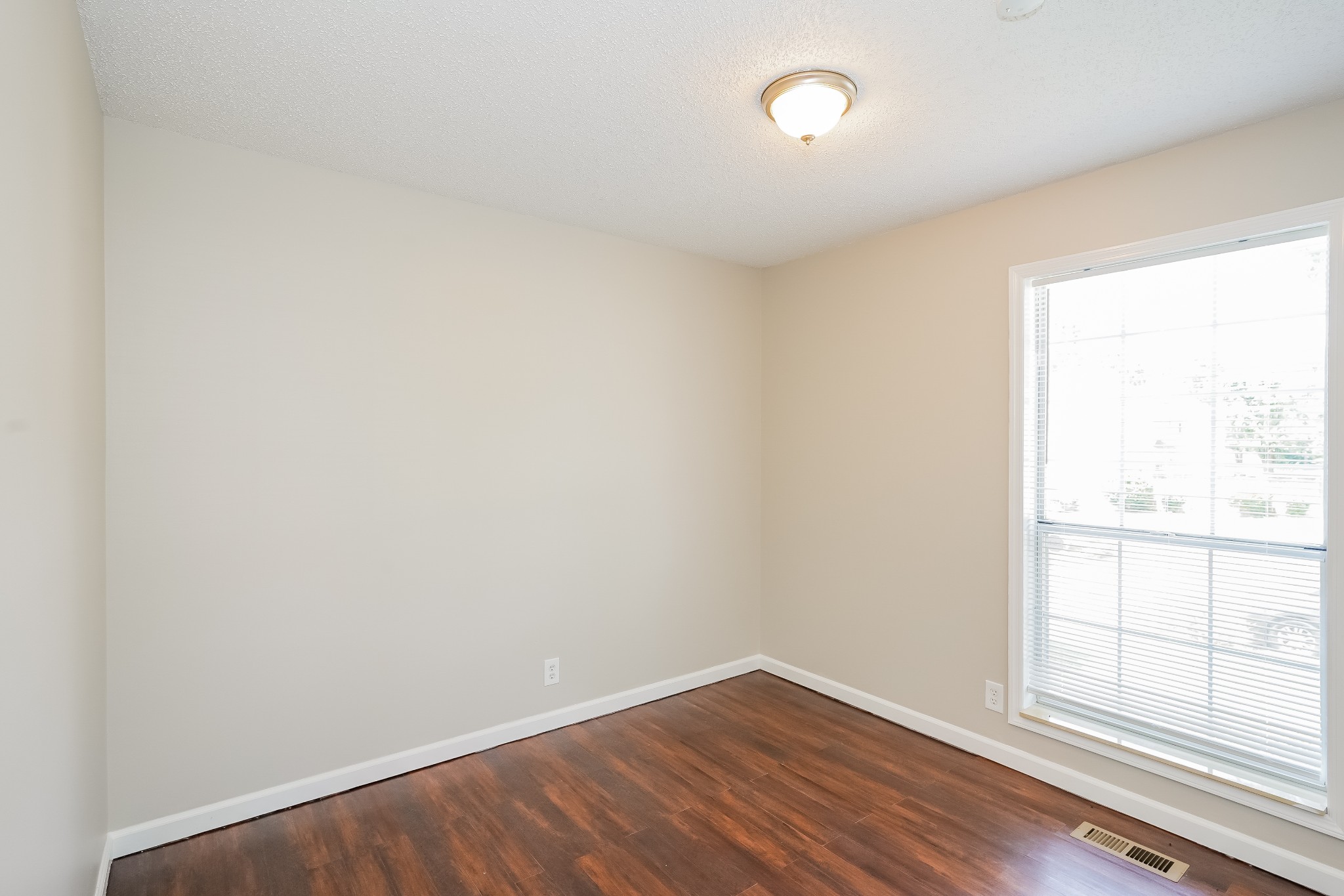 1204 Curran Court Antioch, TN 37013 - Photo 10 of 16 an empty room with wooden floor and windows