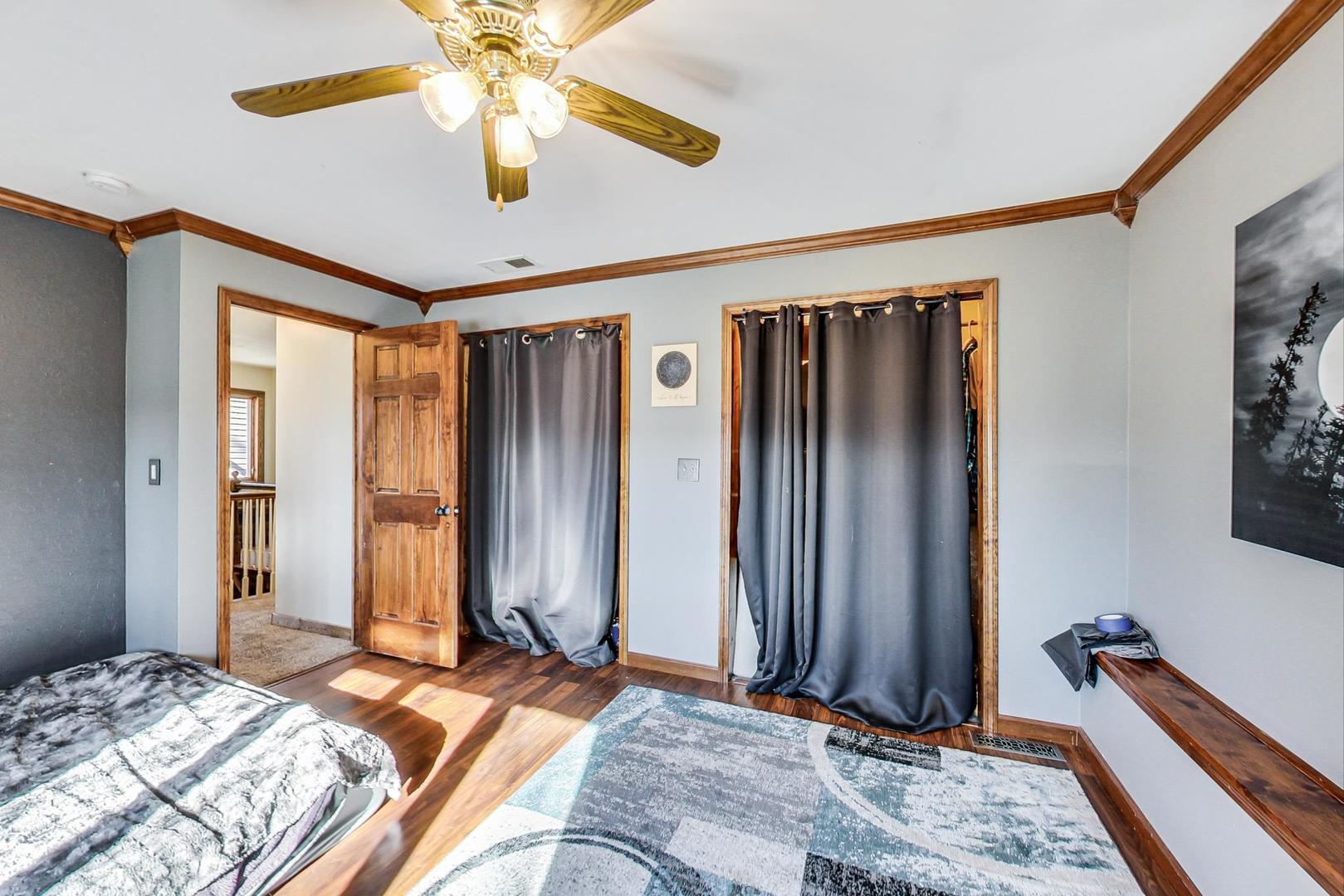 3616 West 116th Street Chicago, IL 60655 - Photo 14 of 33 a bedroom with bed and a chandelier