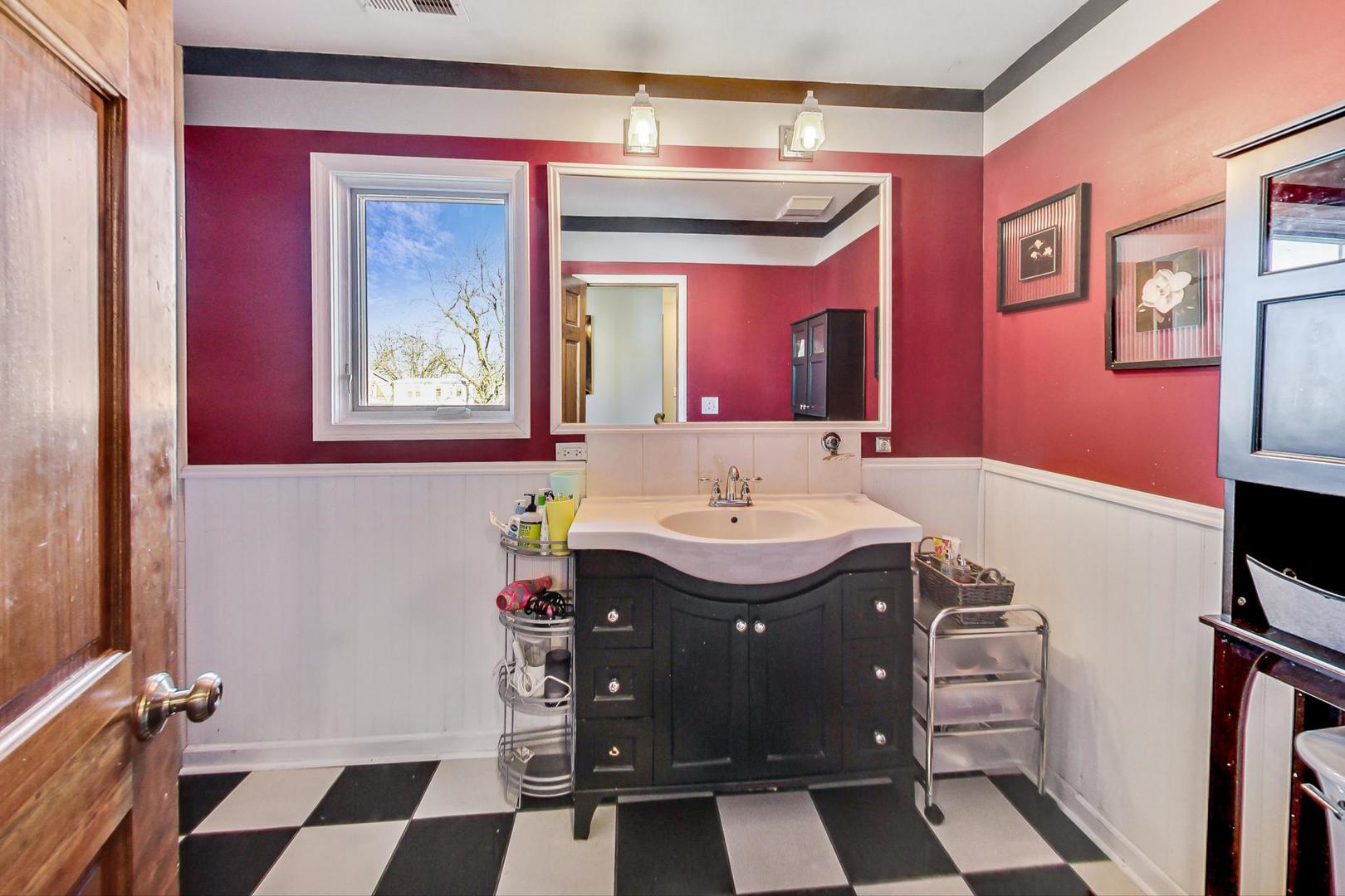 3616 West 116th Street Chicago, IL 60655 - Photo 20 of 33 a bathroom with a sink and a mirror