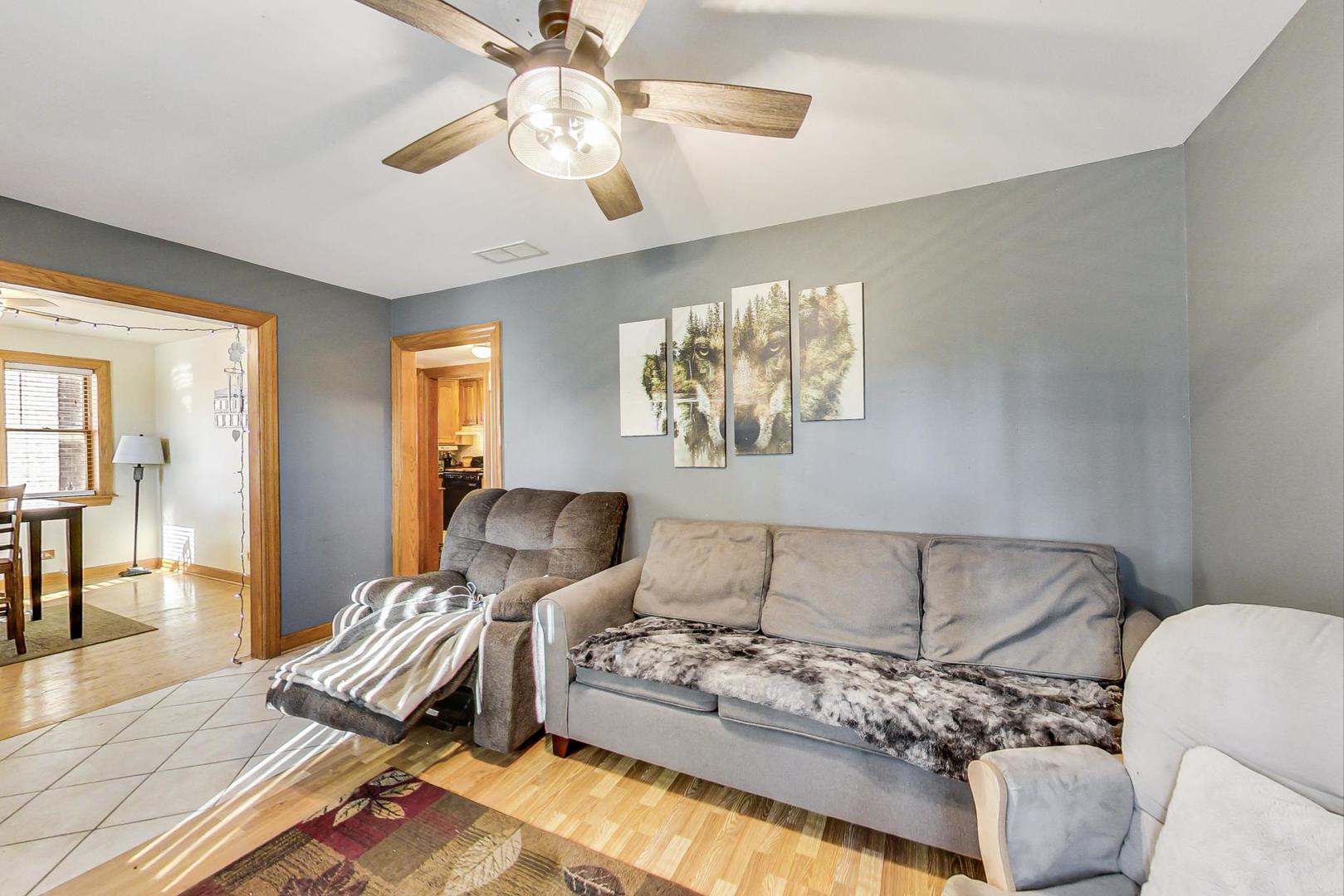 3616 West 116th Street Chicago, IL 60655 - Photo 2 of 33 a living room with furniture and a chandelier