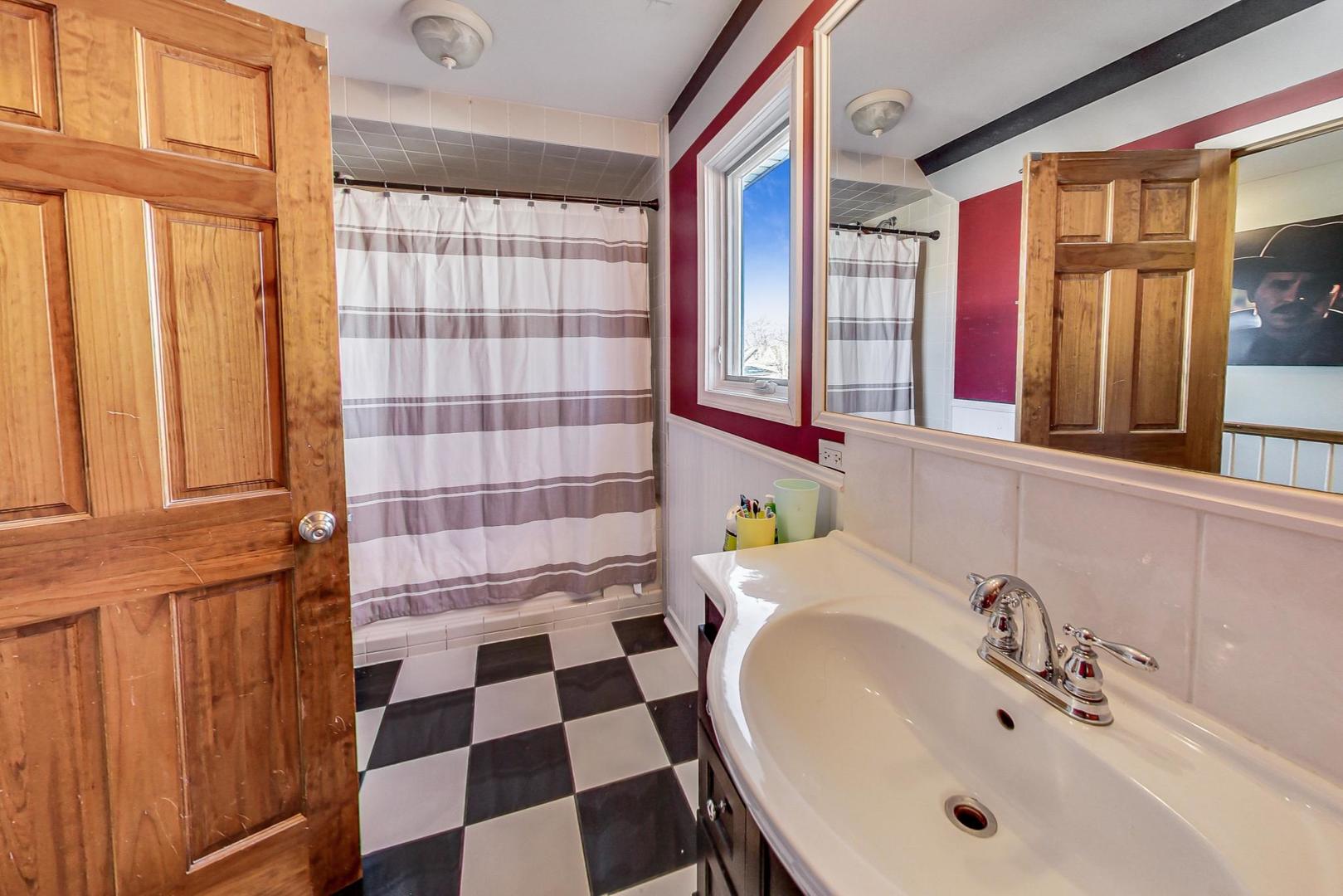3616 West 116th Street Chicago, IL 60655 - Photo 21 of 33 a bathroom with a sink a large mirror and a shower