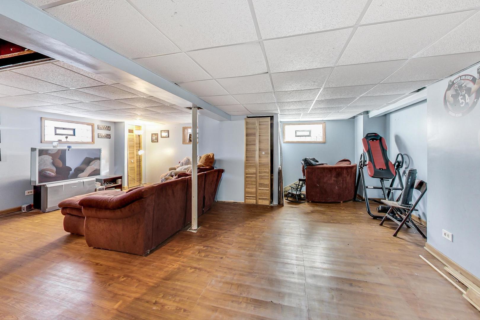 3616 West 116th Street Chicago, IL 60655 - Photo 22 of 33 a living room with furniture and a gym machine