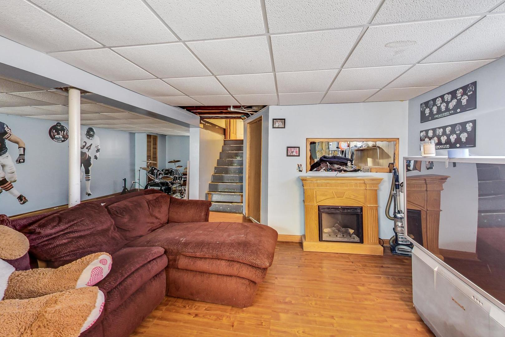 3616 West 116th Street Chicago, IL 60655 - Photo 24 of 33 a living room with furniture and a fireplace