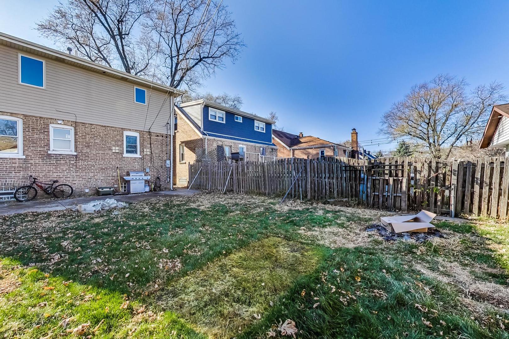 3616 West 116th Street Chicago, IL 60655 - Photo 28 of 33 a backyard of a house with table and chairs