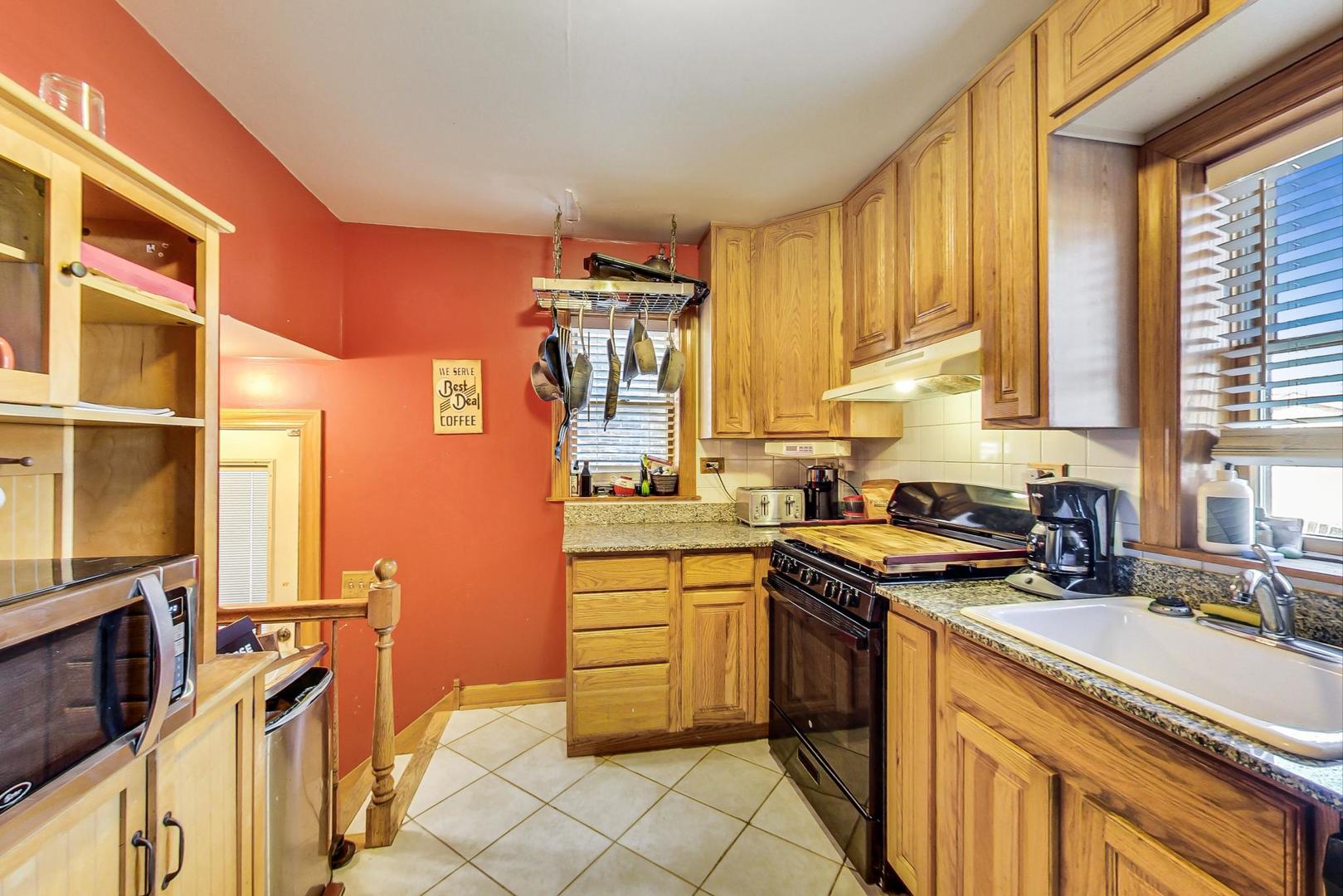 3616 West 116th Street Chicago, IL 60655 - Photo 7 of 33 a kitchen with stainless steel appliances a sink stove and cabinets