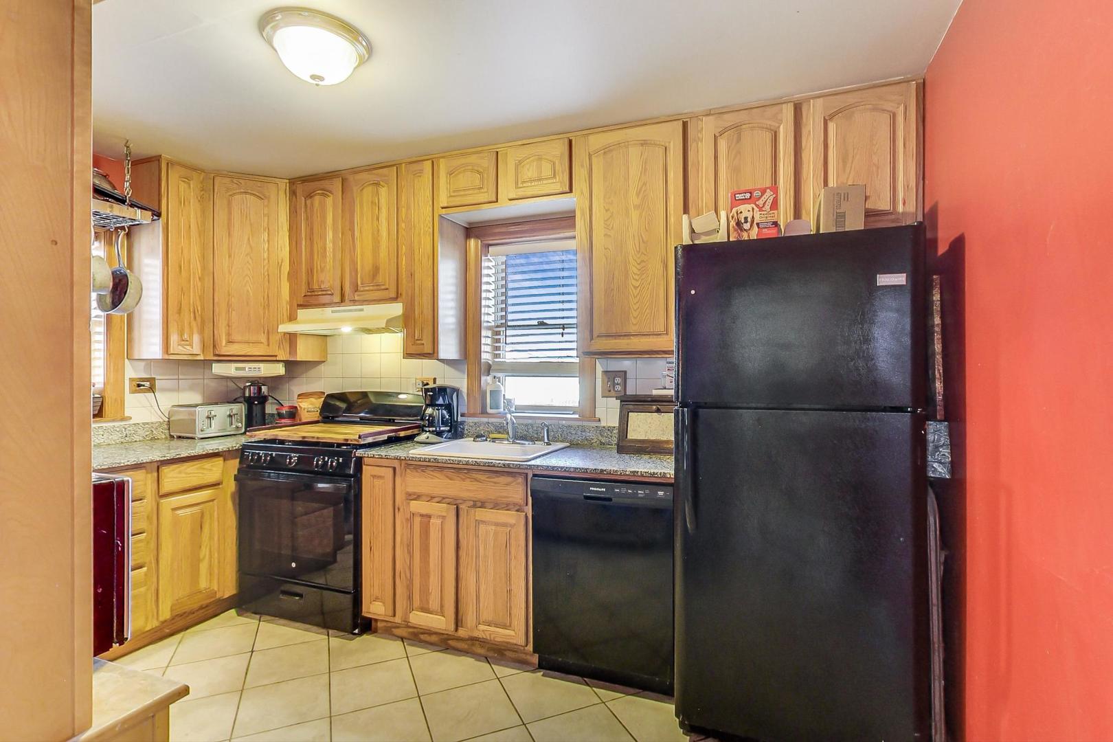 3616 West 116th Street Chicago, IL 60655 - Photo 8 of 33 a kitchen with a sink a refrigerator and cabinets