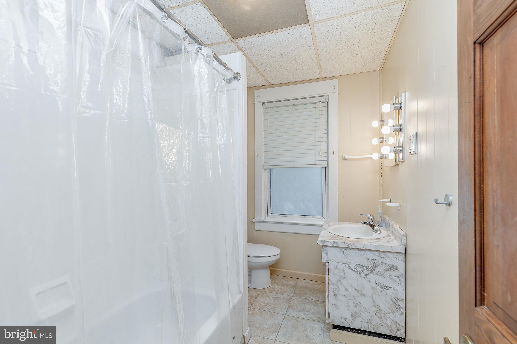 427 Buttonwood Street Delanco, NJ 08075 - Photo 16 of 37 a bathroom with a granite countertop sink a toilet and shower