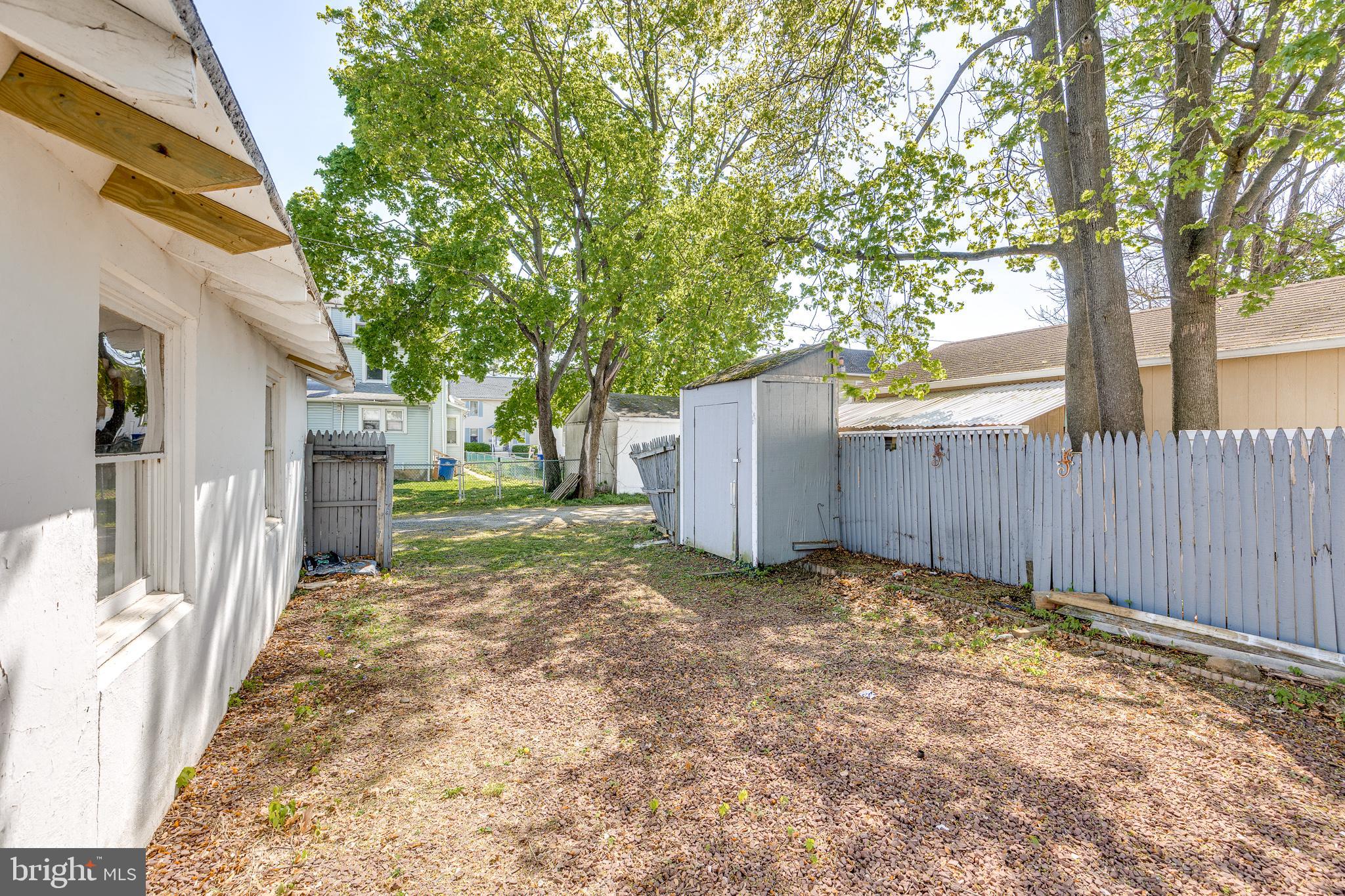 427 Buttonwood Street Delanco, NJ 08075 - Photo 37 of 37 a view of a yard with wooden fence and a large tree