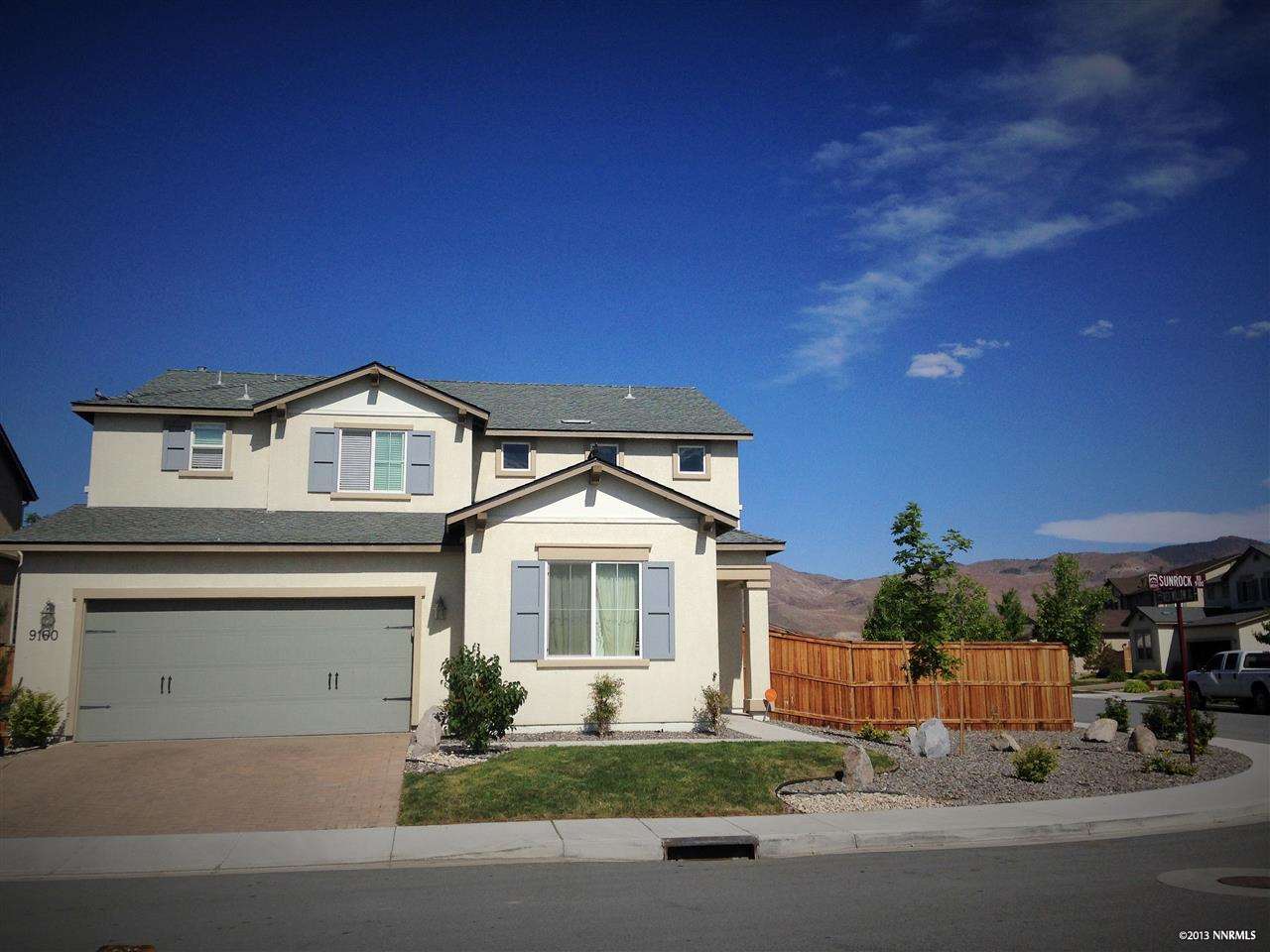 9160 Sunrock Road Reno, NV 89521 - Photo 1 of 1 a front view of a house with a yard and garage