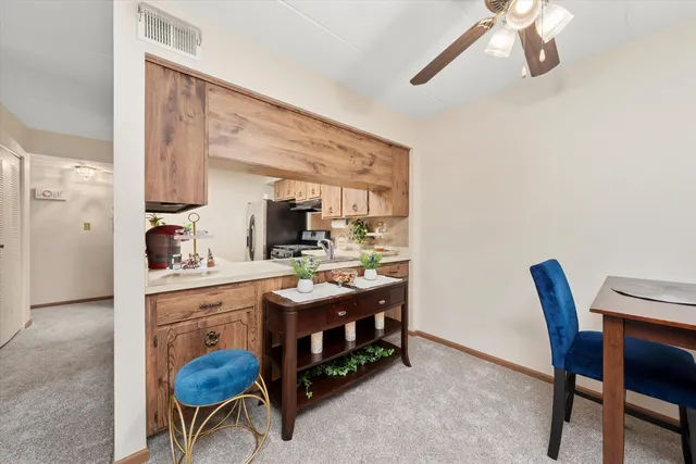 a view of a dining room with furniture and a chandelier