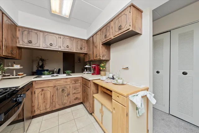 a kitchen with a sink a stove and cabinets