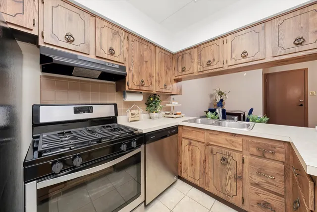 a kitchen with stainless steel appliances granite countertop a stove and cabinets