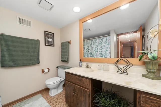 a bathroom with a sink a toilet and mirror