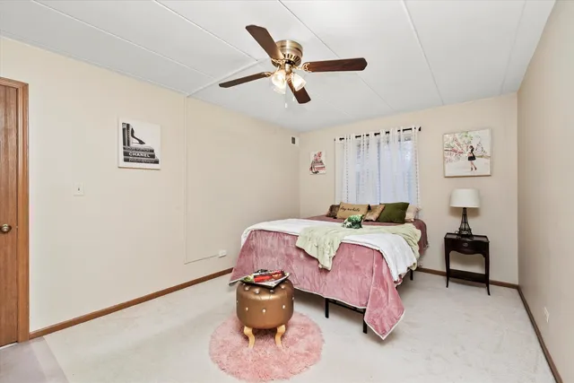 a bedroom with bed and a chandelier