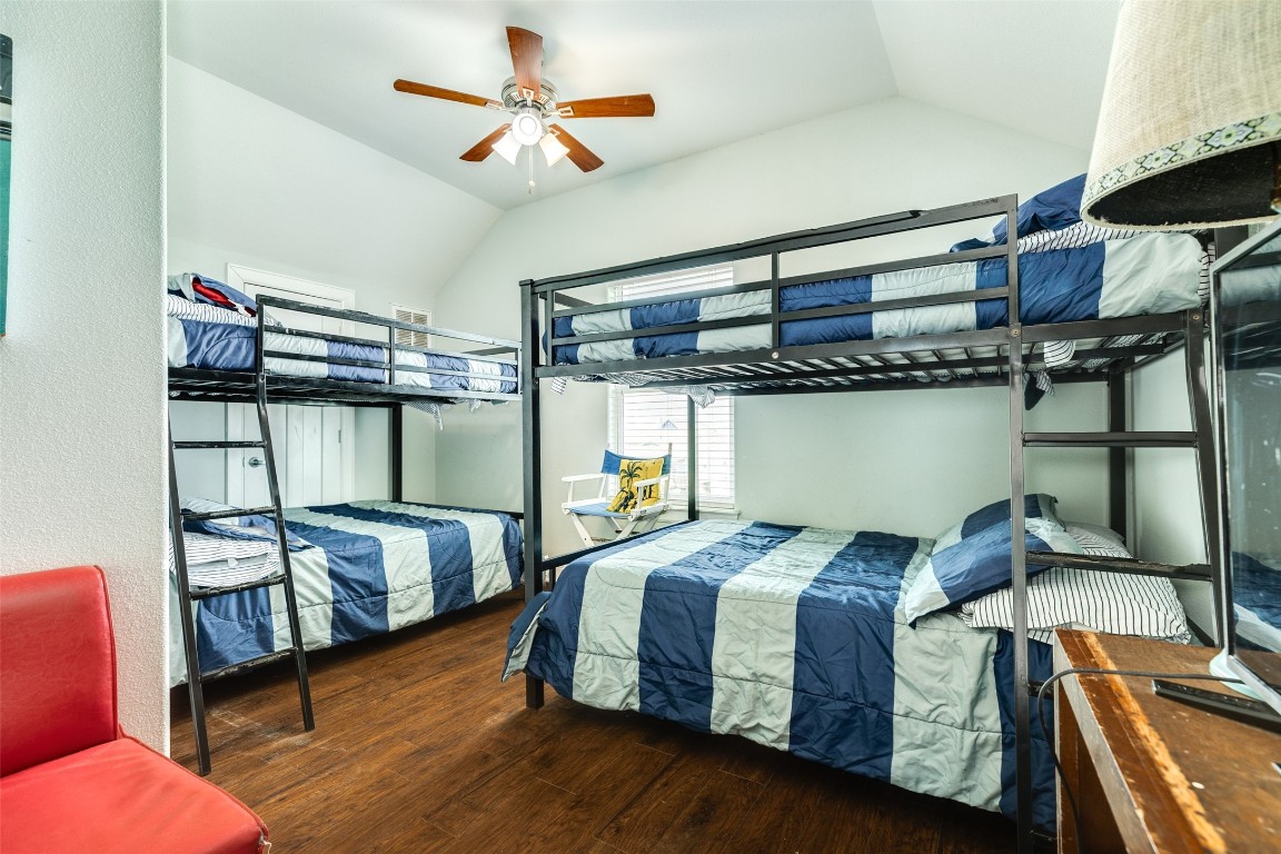 510 Point Lookout Surfside Beach, TX 77541 - Photo 27 of 41 a bedroom with a bed next to a window with a chandelier