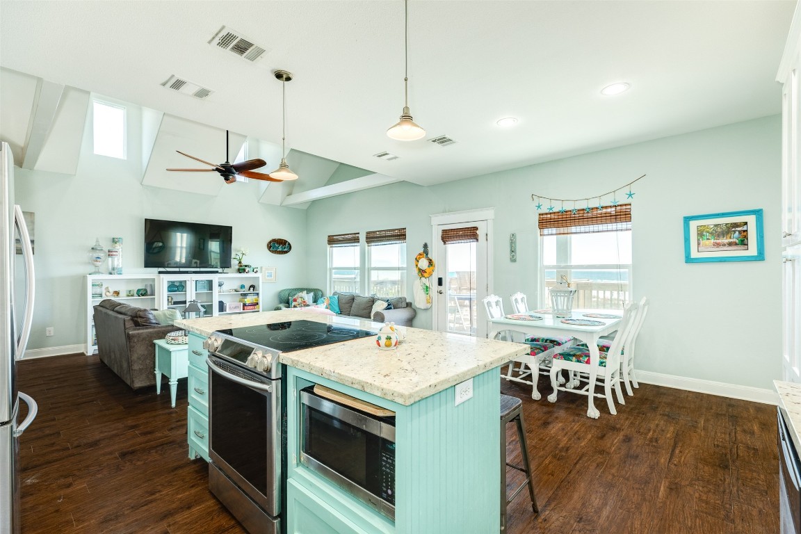 510 Point Lookout Surfside Beach, TX 77541 - Photo 10 of 41 a open kitchen with stainless steel appliances granite countertop a stove and chairs with wooden floors