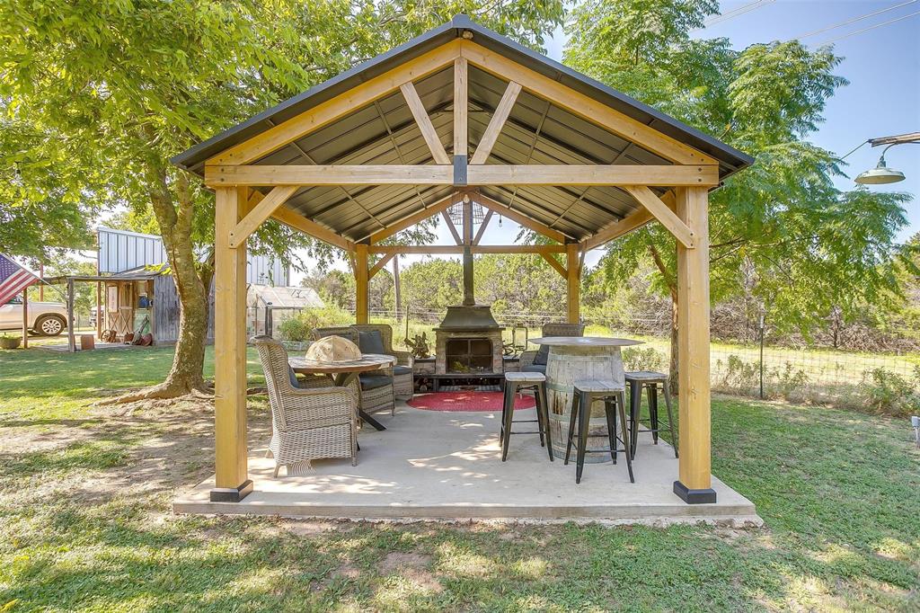 8716 County Road 1224A Rio Vista, TX 76093 - Photo 16 of 38 View of patio / terrace featuring an outdoor stone fireplace