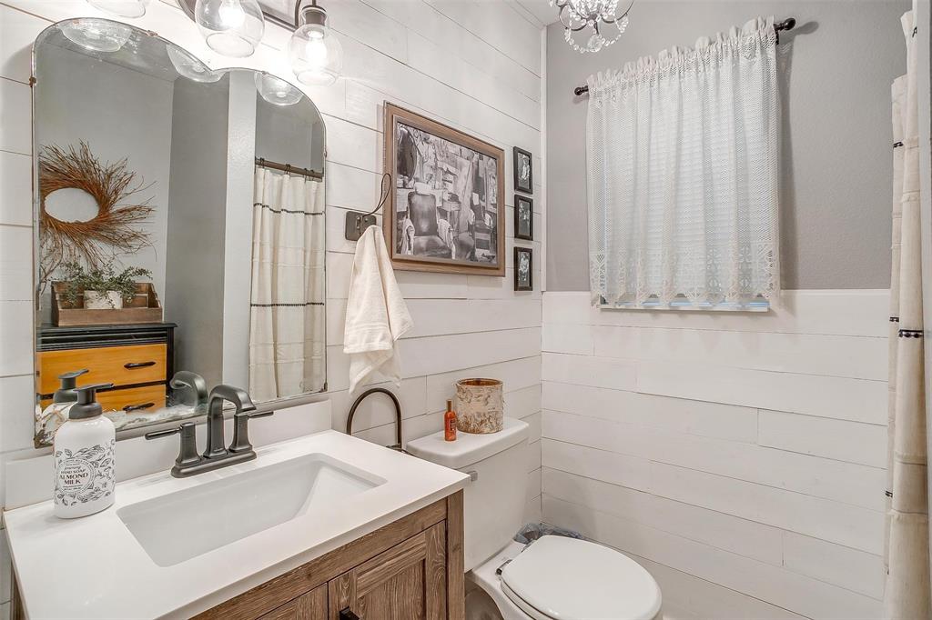 8716 County Road 1224A Rio Vista, TX 76093 - Photo 22 of 38 Full bath featuring vanity, tile walls, and curtained shower